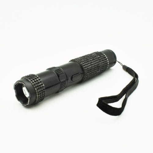 Black tactical flashlight with textured grip and wrist strap, isolated on a white background.