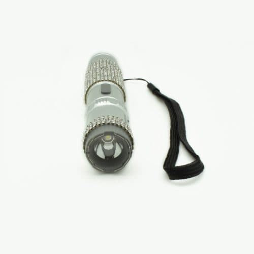 Silver rhinestone flashlight with black strap, featuring textured grip and on/off button, isolated on white background.