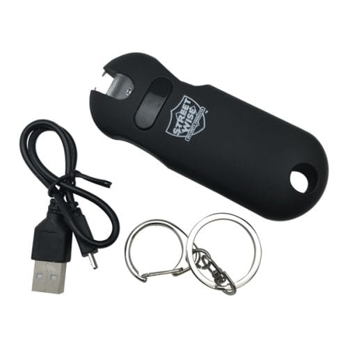 Black keychain stun gun with USB charging cable and key rings for personal safety.