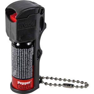 Black compact pepper spray with safety flip top and keychain attachment.