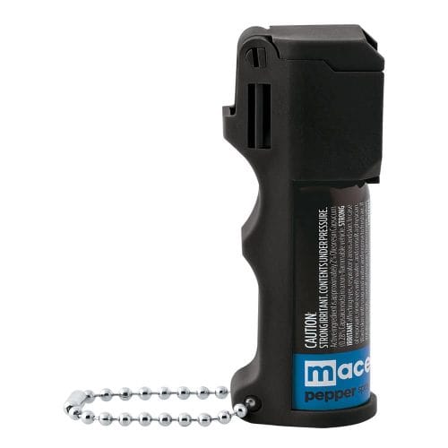 Black pepper spray with safety cap and keychain for personal safety.