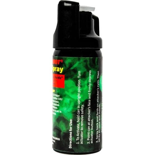 Black and green pepper spray canister for self-defense with text instructions on label.