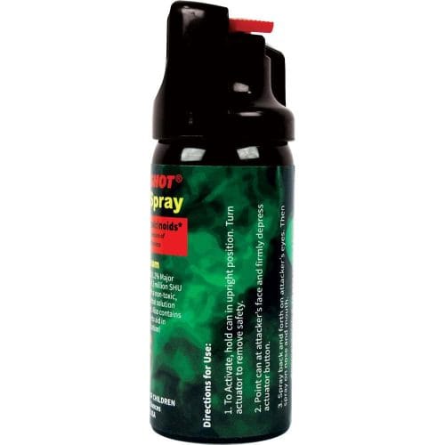 Black pepper spray canister with green and red label, safety instructions, and activation directions visible.