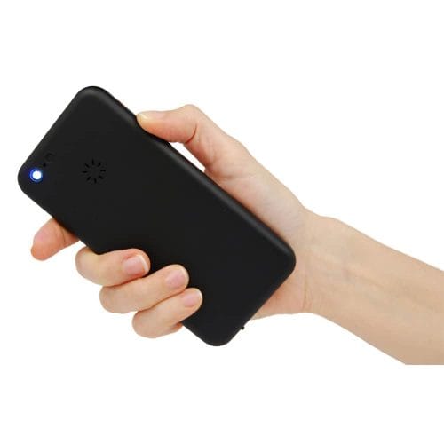 Hand holding a small black device with a blue indicator light, used for communication or connectivity.