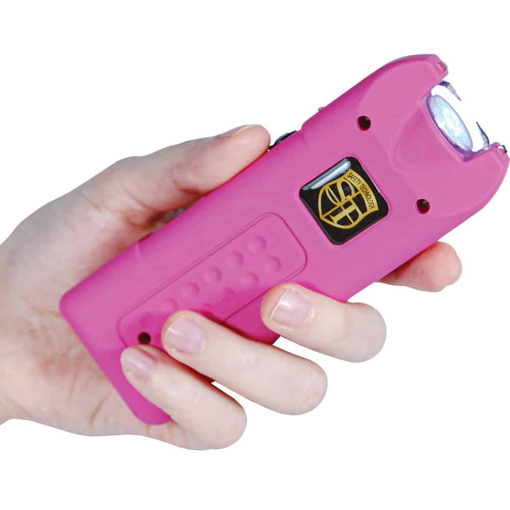 ST-MGSG-PINK_djpg | Para Bellum Defense Hand holding a pink stun gun with a safety switch, ideal for self-defense and personal protection.