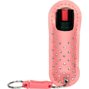 Pink pepper spray keychain with rhinestone-studded holder for personal safety and easy access.