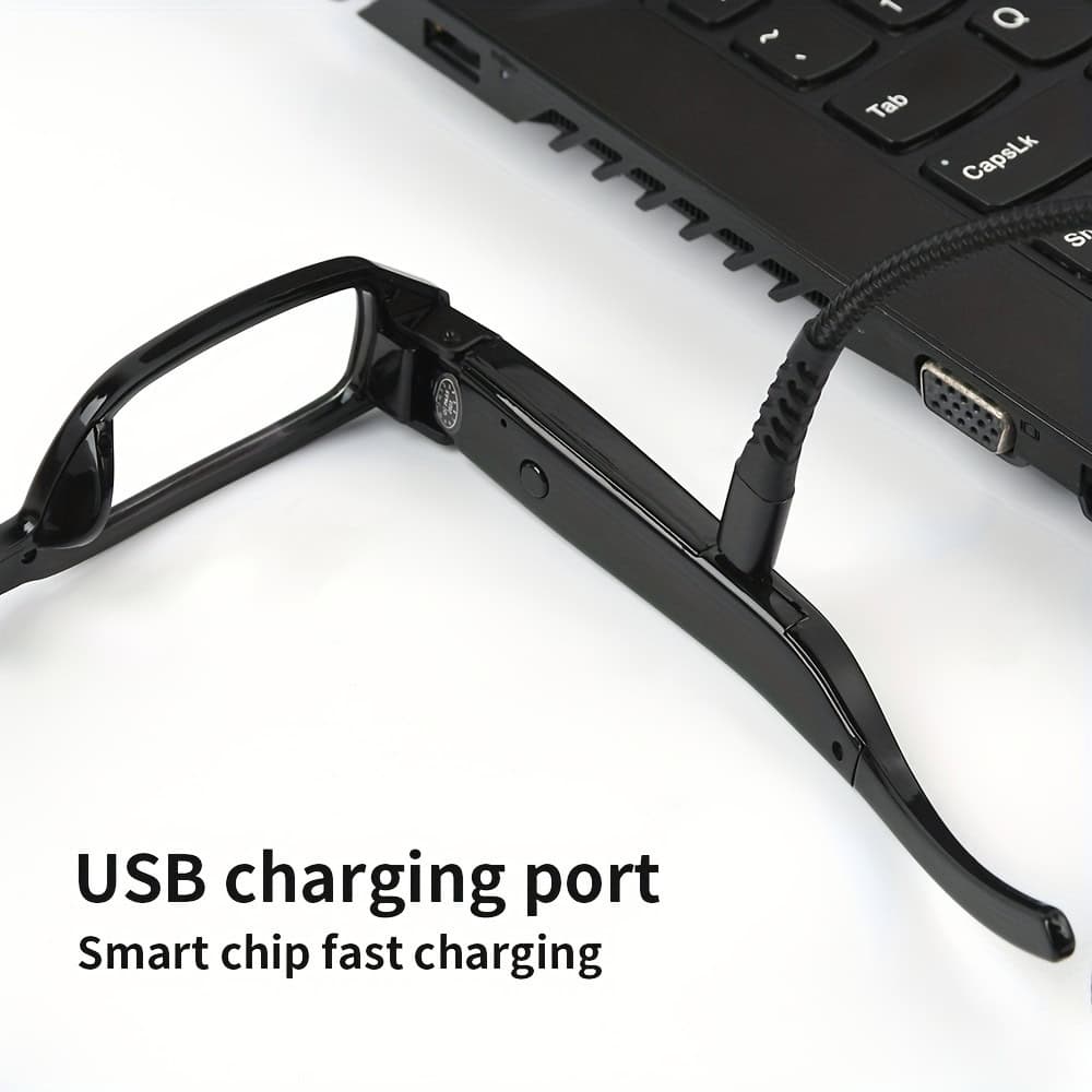 HC-GLASSES_ijpg | Para Bellum Defense Smart glasses with USB charging cable connected to laptop, showcasing fast charge capability.